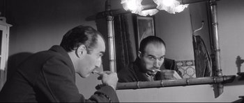 Movie still from “Diary of a Chambermaid” (1964), directed by Luis Buñuel – A man brushing his teeth in front of a mirror; Close Up shot, Low angle