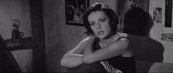 Movie still from “Diary of a Chambermaid” (1964), directed by Luis Buñuel – Black and white photograph of a woman sitting in a chair; Close Up shot, Low angle