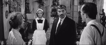 Movie still from “Diary of a Chambermaid” (1964), directed by Luis Buñuel – A man and a woman dressed as maids; Medium shot, Low angle