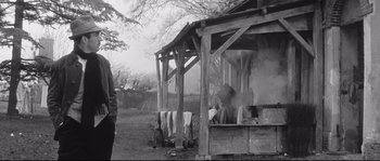 Movie still from “Diary of a Chambermaid” (1964), directed by Luis Buñuel – An old photo of an outdoor kitchen in a field; Medium shot, Low angle