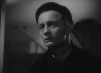 Black and white photograph of a man wearing a hat