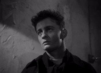 Black and white photograph of a young man looking at the camera
