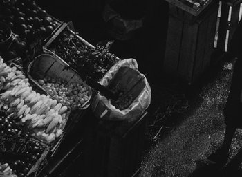 Movie still from “Diary of a Pregnant Woman” (1958), directed by Agnès Varda – An overhead view of a market with baskets of vegetables; Wide shot, Overhead angle