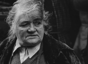 Movie still from “Diary of a Pregnant Woman” (1958), directed by Agnès Varda – An old woman with a very long white hair; Close Up shot, Low angle