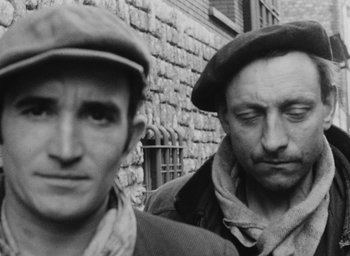 Movie still from “Diary of a Pregnant Woman” (1958), directed by Agnès Varda – A black and white photo of two men standing next to each other; Close Up shot, High angle