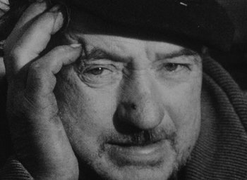 Movie still from “Diary of a Pregnant Woman” (1958), directed by Agnès Varda – An older man wearing a hat and glasses; Close Up shot, Low angle
