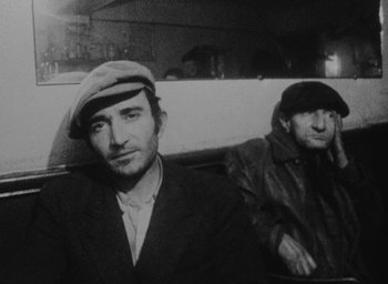 Movie still from “Diary of a Pregnant Woman” (1958), directed by Agnès Varda – A man and a woman sitting next to each other in a car; Medium shot, High angle