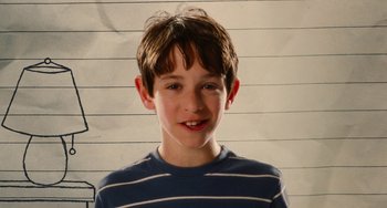 Movie still from “Diary of a Wimpy Kid” (2010), directed by Thor Freudenthal – A young boy is smiling for the camera; Close Up shot, Low angle