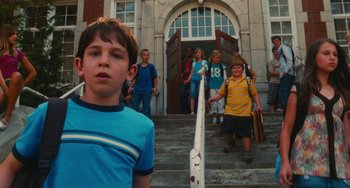 Movie still from “Diary of a Wimpy Kid” (2010), directed by Thor Freudenthal – A group of children walking down the stairs of a school; Medium shot, Low angle