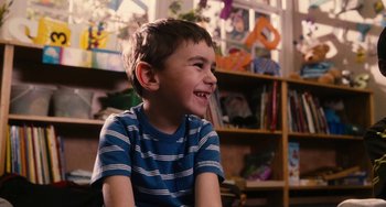 Movie still from “Diary of a Wimpy Kid” (2010), directed by Thor Freudenthal – A young boy sitting in front of a book shelf; Close Up shot, Over the shoulder angle