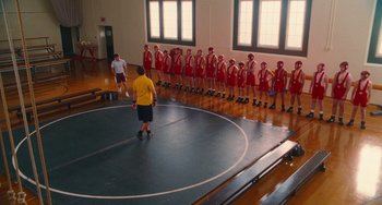 Movie still from “Diary of a Wimpy Kid” (2010), directed by Thor Freudenthal – A group of young men standing on a wrestling mat in a gym; Extreme Wide shot, High angle