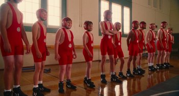 Movie still from “Diary of a Wimpy Kid” (2010), directed by Thor Freudenthal – A group of young men in red wrestling outfits; Wide shot, Low angle