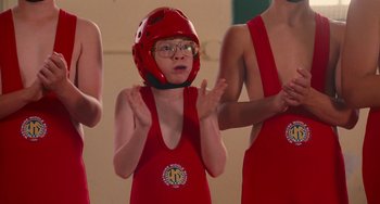 Movie still from “Diary of a Wimpy Kid” (2010), directed by Thor Freudenthal – A young girl wearing a red helmet in front of a group of people; Medium shot, Low angle