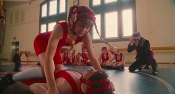 Movie still from “Diary of a Wimpy Kid” (2010), directed by Thor Freudenthal – A girl in a red dress wrestling a boy in a red outfit; Medium shot, Over the shoulder angle