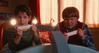 Movie still from “Diary of a Wimpy Kid” (2010), directed by Thor Freudenthal – Two young boys are playing a video game together; Medium shot, High angle