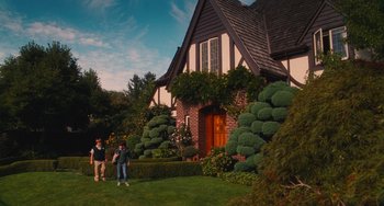 Movie still from “Diary of a Wimpy Kid” (2010), directed by Thor Freudenthal – Two people standing in front of a brick house; Wide shot, Low angle