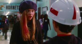Movie still from “Diary of a Wimpy Kid” (2010), directed by Thor Freudenthal – A girl in a purple jacket and a man in a white hat; Medium shot, Over the shoulder angle