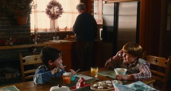 Movie still from “Diary of a Wimpy Kid” (2010), directed by Thor Freudenthal – Two children sitting at a table eating food; Medium shot, Over the shoulder angle