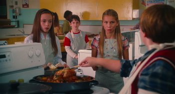 Movie still from “Diary of a Wimpy Kid” (2010), directed by Thor Freudenthal – A group of children in aprons preparing food in a kitchen; Medium shot, Over the shoulder angle