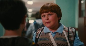 Movie still from “Diary of a Wimpy Kid” (2010), directed by Thor Freudenthal – A young boy with a brown hair and a blue shirt; Close Up shot, Over the shoulder angle