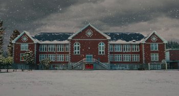 Movie still from “Diary of a Wimpy Kid” (2010), directed by Thor Freudenthal – A red brick building with a clock on the front; Extreme Wide shot, Low angle