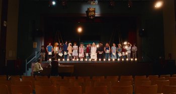 Movie still from “Diary of a Wimpy Kid” (2010), directed by Thor Freudenthal – A group of people standing on top of a stage; Extreme Wide shot, High angle