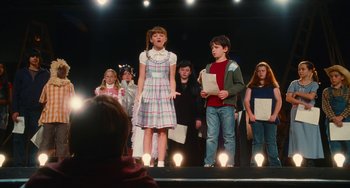Movie still from “Diary of a Wimpy Kid” (2010), directed by Thor Freudenthal – A group of children on a stage singing a song; Medium shot, Low angle