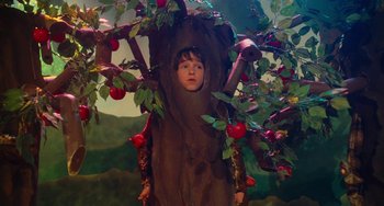 Movie still from “Diary of a Wimpy Kid” (2010), directed by Thor Freudenthal – A boy in a tree costume with apples; Wide shot, High angle