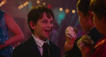 Movie still from “Diary of a Wimpy Kid” (2010), directed by Thor Freudenthal – A boy in a suit and tie holding an ice cream cone; Close Up shot, Over the shoulder angle