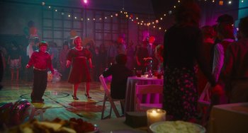 Movie still from “Diary of a Wimpy Kid” (2010), directed by Thor Freudenthal – A group of people standing in a room with lights; Wide shot, Over the shoulder angle
