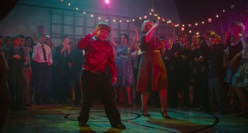 Movie still from “Diary of a Wimpy Kid” (2010), directed by Thor Freudenthal – A group of people dancing in a room with lights in the background; Wide shot, Low angle