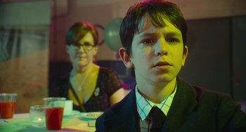 Movie still from “Diary of a Wimpy Kid” (2010), directed by Thor Freudenthal – A boy and a woman sitting at a dinner table; Close Up shot, Over the shoulder angle