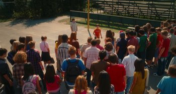Movie still from “Diary of a Wimpy Kid” (2010), directed by Thor Freudenthal – A group of people standing in front of an audience; Extreme Wide shot, High angle