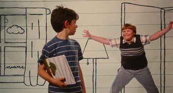 Movie still from “Diary of a Wimpy Kid” (2010), directed by Thor Freudenthal – Two young boys are playing a game in front of a wall; Medium shot, Low angle