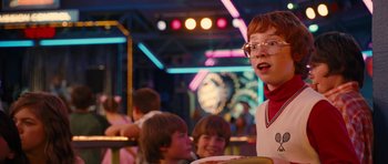 Movie still from “Diary of a Wimpy Kid: Rodrick Rules” (2011), directed by David Bowers – A person with glasses is holding a tray of food; Medium shot, Over the shoulder angle