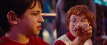 Movie still from “Diary of a Wimpy Kid: Rodrick Rules” (2011), directed by David Bowers – A boy and a girl holding a straw in their mouth; Close Up shot, Over the shoulder angle