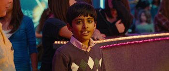 Movie still from “Diary of a Wimpy Kid: Rodrick Rules” (2011), directed by David Bowers – A young boy is smiling for the camera; Medium shot, High angle