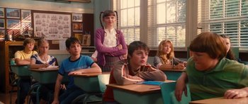 Movie still from “Diary of a Wimpy Kid: Rodrick Rules” (2011), directed by David Bowers – A group of children sitting at desks in a class room; Medium shot, Over the shoulder angle