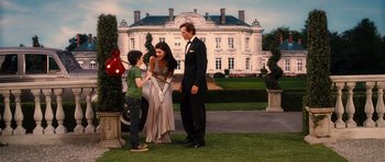 Movie still from “Diary of a Wimpy Kid: Rodrick Rules” (2011), directed by David Bowers – A man and a woman standing next to a young boy; Wide shot, Over the shoulder angle