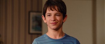 Movie still from “Diary of a Wimpy Kid: Rodrick Rules” (2011), directed by David Bowers – A young boy is smiling for the camera; Close Up shot, Over the shoulder angle