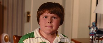 Movie still from “Diary of a Wimpy Kid: Rodrick Rules” (2011), directed by David Bowers – A young boy with brown hair wearing a green and white shirt; Close Up shot, High angle