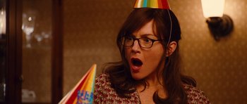 Movie still from “Diary of a Wimpy Kid: Rodrick Rules” (2011), directed by David Bowers – A woman wearing glasses and a party hat is looking surprised; Close Up shot, Over the shoulder angle