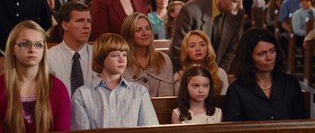 Movie still from “Diary of a Wimpy Kid: Rodrick Rules” (2011), directed by David Bowers – A group of people sitting in a row of pews; Medium shot, High angle