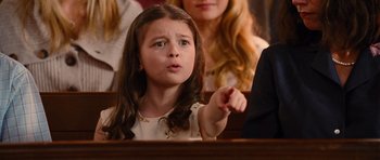 Movie still from “Diary of a Wimpy Kid: Rodrick Rules” (2011), directed by David Bowers – A little girl pointing at something in the audience; Medium shot, Low angle