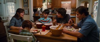 Movie still from “Diary of a Wimpy Kid: Rodrick Rules” (2011), directed by David Bowers – Three people sitting at a table with bowls of food on it; Medium shot, Over the shoulder angle