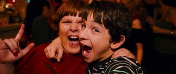 Movie still from “Diary of a Wimpy Kid: Rodrick Rules” (2011), directed by David Bowers – Two young boys are laughing and making funny faces; Close Up shot, Overhead angle