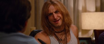 Movie still from “Diary of a Wimpy Kid: Rodrick Rules” (2011), directed by David Bowers – A man with long hair is sitting down; Close Up shot, Over the shoulder angle