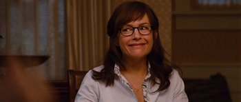 Movie still from “Diary of a Wimpy Kid: Rodrick Rules” (2011), directed by David Bowers – A woman wearing glasses sitting in front of a window; Close Up shot, Over the shoulder angle