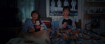 Movie still from “Diary of a Wimpy Kid: Rodrick Rules” (2011), directed by David Bowers – Two boys sitting in a bed with a monkey toy; Medium shot, High angle