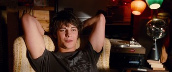 Movie still from “Diary of a Wimpy Kid: Rodrick Rules” (2011), directed by David Bowers – A man sitting in a chair with his arms behind his head; Close Up shot, Over the shoulder angle